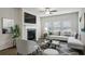 Spacious living room with a fireplace and L-shaped sofa at 7788 Richmond Trl, Fairburn, GA 30213