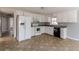 White kitchen cabinets, black appliances, and tile floor at 143 Longview Rd, Fayetteville, GA 30214