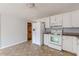 Kitchen with white cabinets, appliances, and tile floor at 143 Longview Rd, Fayetteville, GA 30214