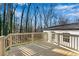 Wood deck with natural-looking railings overlooking the lawn and backyard trees at 3251 Stoney Acres Nw Dr, Kennesaw, GA 30152