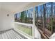 This covered back porch has white wooden posts, neutral paint, and overlooks a wooded area at 3251 Stoney Acres Nw Dr, Kennesaw, GA 30152