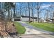Long driveway leading to a lovely home with an attached garage at 3251 Stoney Acres Nw Dr, Kennesaw, GA 30152