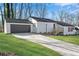 Charming single-story home features a driveway, attached garage, and landscaped yard at 3251 Stoney Acres Nw Dr, Kennesaw, GA 30152