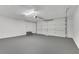 Spacious garage featuring white walls, grey floor, and a white door at 3251 Stoney Acres Nw Dr, Kennesaw, GA 30152