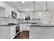 Modern kitchen with sleek cabinetry, stainless appliances and stylish pendant lights at 3251 Stoney Acres Nw Dr, Kennesaw, GA 30152