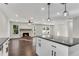 Open-concept kitchen and living room with a granite island and fireplace at 3251 Stoney Acres Nw Dr, Kennesaw, GA 30152