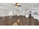 Open living room with hardwood floors and a modern kitchen with stainless steel appliances at 3251 Stoney Acres Nw Dr, Kennesaw, GA 30152