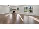 Bright living room with hardwood floors and a fireplace with stone surround at 3251 Stoney Acres Nw Dr, Kennesaw, GA 30152