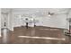 Spacious open-concept living room featuring hardwood floors, a fireplace, and a modern kitchen at 3251 Stoney Acres Nw Dr, Kennesaw, GA 30152