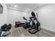 Well-lit exercise room in the basement has modern equipment, offering a private and convenient workout space at 4973 Concert Ln, Marietta, GA 30066