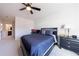 Cozy bedroom with plush carpeting, blue accents, and a ceiling fan at 4973 Concert Ln, Marietta, GA 30066
