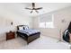 Cozy bedroom featuring a full bed with white walls, soft carpet, and a ceiling fan, providing a serene and comfortable atmosphere at 4973 Concert Ln, Marietta, GA 30066