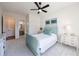 Bright bedroom features neutral carpet, a ceiling fan, and light blue decor and furnishings at 4973 Concert Ln, Marietta, GA 30066