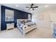 Stylish bedroom featuring a navy accent wall, white furnishings, and ample natural light at 4973 Concert Ln, Marietta, GA 30066