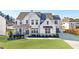 Beautiful two-story home with a covered front porch and professionally landscaped yard and a long driveway at 4973 Concert Ln, Marietta, GA 30066