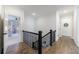 Hallway with hardwood floors and black metal railing leads to other rooms at 4973 Concert Ln, Marietta, GA 30066