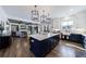 Open kitchen with island connecting to the living room with a fireplace and built-in shelving at 4973 Concert Ln, Marietta, GA 30066