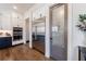 A gourmet kitchen boasts stainless steel appliances, custom cabinetry, and a pantry door with decorative glass at 4973 Concert Ln, Marietta, GA 30066