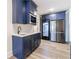 Kitchenette features stylish blue cabinetry, a microwave, a sink, and a stainless steel refrigerator at 4973 Concert Ln, Marietta, GA 30066