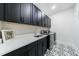 Laundry room featuring a sink, countertop, cabinets, and stainless-steel washer and dryer at 4973 Concert Ln, Marietta, GA 30066