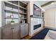 Cozy living room with custom shelving, a modern fireplace, and a flat screen television above at 4973 Concert Ln, Marietta, GA 30066