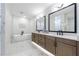 The main bathroom has double vanities, a soaking tub, and marble floors in a modern design at 4973 Concert Ln, Marietta, GA 30066