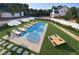 Aerial view of a backyard pool with lounge chairs, umbrellas, and a well-maintained lawn, perfect for relaxation and outdoor entertainment at 4973 Concert Ln, Marietta, GA 30066