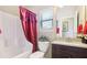 Clean bathroom with a tub, shower, and dark wood vanity at 709 Chapman St, Jonesboro, GA 30238