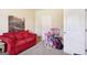 Charming bedroom featuring red couch and toys at 709 Chapman St, Jonesboro, GA 30238