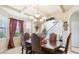 Bright dining room featuring a large table and access to staircase at 709 Chapman St, Jonesboro, GA 30238
