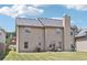 Two-story house with beige siding, a yard, and a patio at 709 Chapman St, Jonesboro, GA 30238