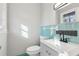 Updated bathroom with teal tile and modern vanity at 1120 Starline Se Dr, Smyrna, GA 30080