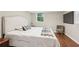 Cozy bedroom with neutral decor, wood floors, and a large window offering natural light at 1120 Starline Se Dr, Smyrna, GA 30080