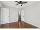 Well-lit bedroom with hardwood floors, ceiling fan and access to a bathroom at 1120 Starline Se Dr, Smyrna, GA 30080