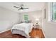 Bright bedroom features wood floors, ceiling fan, and a window offering plenty of natural light at 1120 Starline Se Dr, Smyrna, GA 30080