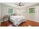 Well-lit bedroom features wood floors, ceiling fan, and two windows offering plenty of natural light at 1120 Starline Se Dr, Smyrna, GA 30080