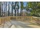 Wooden deck with sunburst design and wooded backyard view at 1120 Starline Se Dr, Smyrna, GA 30080
