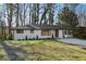 White brick ranch house with a nicely landscaped yard and a long driveway at 1120 Starline Se Dr, Smyrna, GA 30080