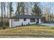 Charming ranch home with white brick exterior, updated landscaping, and a spacious driveway at 1120 Starline Se Dr, Smyrna, GA 30080