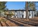 Back of house, white brick, deck, and wooded area at 1120 Starline Se Dr, Smyrna, GA 30080