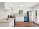 Bright kitchen features white cabinets, stainless appliances, granite counters, and wood floors at 1120 Starline Se Dr, Smyrna, GA 30080