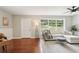 Bright living room with hardwood floors, a sofa, and a large window with backyard views at 1120 Starline Se Dr, Smyrna, GA 30080