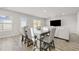 Dining area with gray table and chairs, hardwood floors, and open layout at 12 Enclave Blvd, Covington, GA 30014
