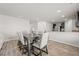 Dining area with gray table and chairs, hardwood floors, open to kitchen at 12 Enclave Blvd, Covington, GA 30014