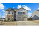 Two-story house with brick and siding, two-car garage, and a well-manicured lawn at 12 Enclave Blvd, Covington, GA 30014