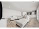 Spacious living room with L-shaped sofa, hardwood floors, and view to kitchen at 12 Enclave Blvd, Covington, GA 30014