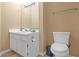 Clean bathroom with white vanity, toilet, and a large mirror at 2618 Windage Sw Dr, Marietta, GA 30008