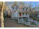 Two-story house with light beige siding, a wraparound porch, and a white railing at 2618 Windage Sw Dr, Marietta, GA 30008