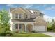 Two-story brick home with light-colored siding, a large garage, and landscaping at 3229 Shirecrest Ln, Dacula, GA 30019