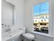 Powder room featuring a single sink vanity, toilet, and a bright window at 238 Lytham Se Dr, Mableton, GA 30126